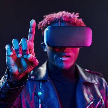 Virtual reality experience. Futuristic neon lighting. Young african american man in the studio.